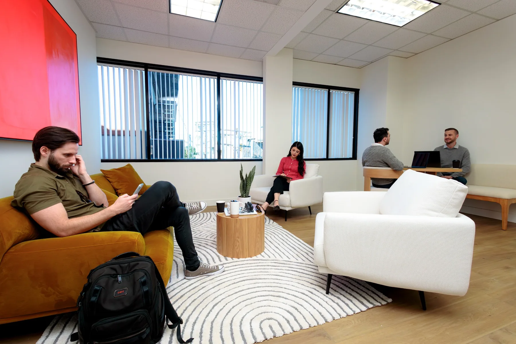 People using the shared lounge at Evolved Therapy